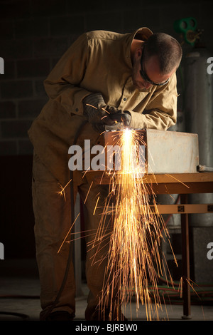 USA, Utah, Orem, man welding metal in workshop Stock Photo