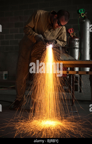 USA, Utah, Orem, man welding metal in workshop Stock Photo