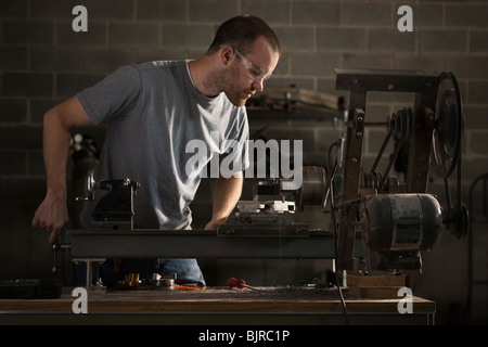 USA, Utah, Orem, man using machine in workshop Stock Photo