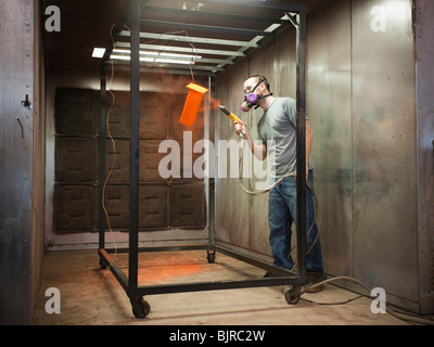 USA, Utah, Orem, man using paint spray gun Stock Photo