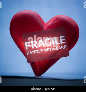 Heart with sign reading fragile Stock Photo