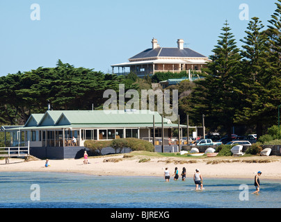 PEOPLE PADDLING IN WATER, BEACH AND BUILDINGS AT SORRENTO MORNINGTON PENINSULA  VICTORIA AUSTRALIA Stock Photo