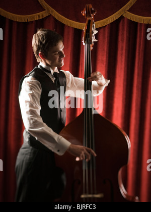 Young man playing double bass Stock Photo