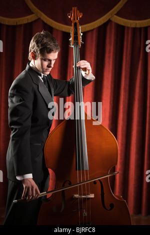 Young man playing double bass Stock Photo