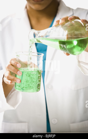 Scientist mixing chemicals Stock Photo