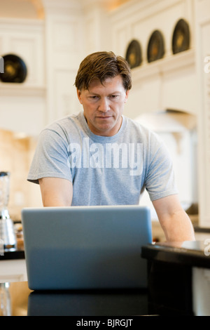USA, Utah, Alpine, mature man standing and using laptop Stock Photo