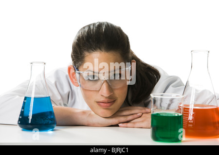 Female scientist looking at chemicals in a lab Stock Photo