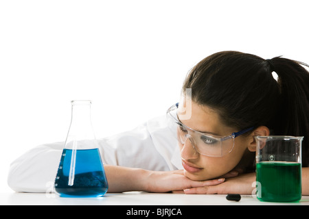 Female scientist looking at chemicals in a lab Stock Photo