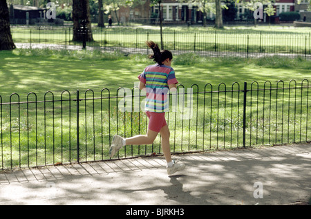 young woman jogging in the park Stock Photo