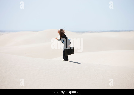 USA, Utah, Little Sahara, young businesswoman standing on desert Stock Photo