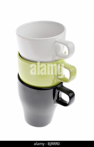 Three stacked white green and black coffee cups isolated on white Stock Photo