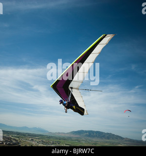 USA, Utah, Lehi, mid adult man hang gliding, low angle view Stock Photo