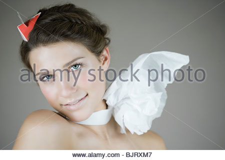 Young woman wearing only a bow tie over her naked breasts 