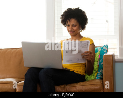 USA, Utah, Provo, young woman using laptop on couch