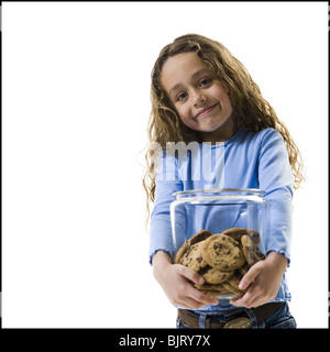 Young girl holding cookie jar Stock Photo