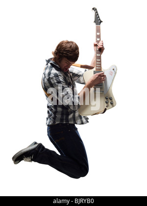 Young man playing electric guitar and jumping Stock Photo