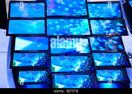 flat lcd tv screens on a wall hd digital electronic hdtv high definition technology television media multimedia television blue Stock Photo