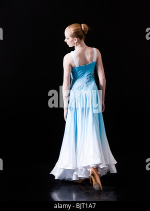 Young woman posing as professional dancer, studio shot Stock Photo