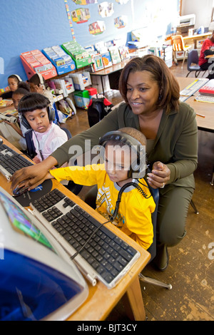 Detroit, Michigan - First grade teacher Ivy Bailey teaches computer use at MacDowell Elementary School. Stock Photo