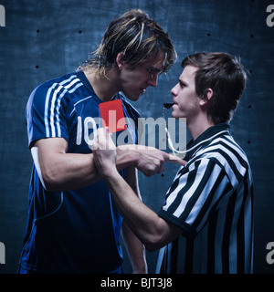 Studio shot of referee showing red card Stock Photo