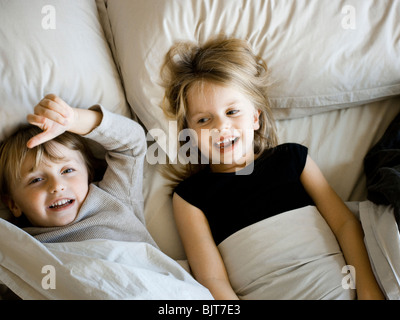 USA, Utah, Provo, Portrait of brother and sister (2-5) lying in bed Stock Photo