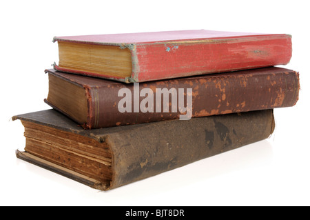 Old books piled together over white background Stock Photo
