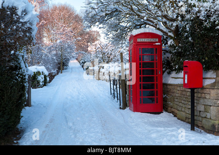 Dusk falling on winter snow and the Cotswold Way in the Cotswold village of Stanton, Gloucestershire UK Stock Photo