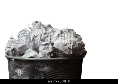 Waste bin full of screwed up pieces of paper. Cutout on a white background with space for copy. Stock Photo