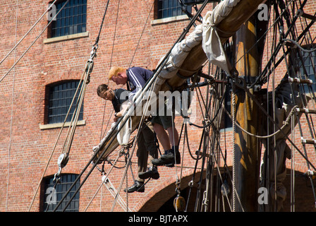 Young persons in the mast rigging of a sailing ship, the Zebu.  Albert Dock, Liverpool, Merseyside, England, UK Stock Photo
