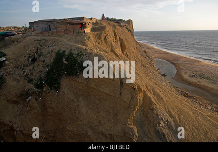 A slum built into the rock on the outskirts of Sumbe town  Namibe coastline. Namibe Province, Southern Angola. Africa. Stock Photo