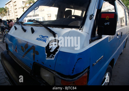 A minibus taxi with a sticker of the Cuban revolutionary Che Guevara and a sticker of the Angolan flag. Benguela, Angola. Africa Stock Photo