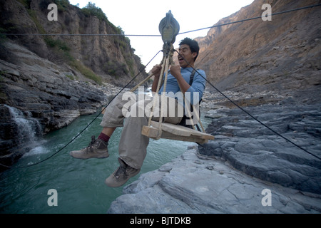 Crossing the hanging bridge in Colca Canyon Valley, the deepest canyon on Earth. Peru, South America Stock Photo