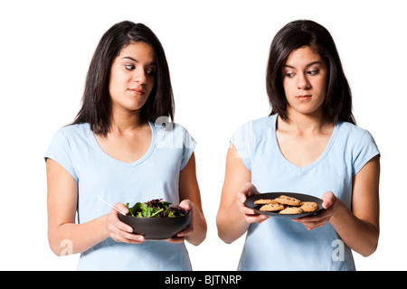 Sisters offering salad and cookies Stock Photo