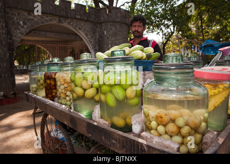 India, Kerala, Palakkad, roadside vendor selling pickled mangoes and fruit at entrance to fort Stock Photo