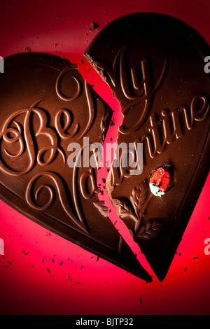 Chocolate valentine heart broken in two Stock Photo