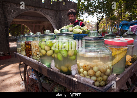India, Kerala, Palakkad, roadside vendor selling pickled mangoes and other fruit at entrance to fort Stock Photo