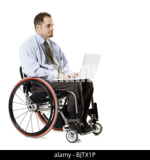 Man in wheelchair with laptop Stock Photo