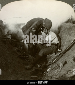 Soldier receiving first aid from a sergeant in a sap, Battle of Peronne, World War I, 1914-1918.Artist: Realistic Travels Publishers Stock Photo