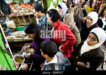 Palestinians and Israelis buy spices in a famous spice shop in the Muslim quarter of the old city in Jerusalem. Stock Photo