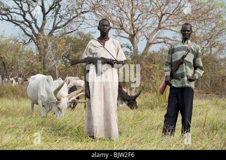 South-Sudan, Cuibet near Rumbek , young Dinka shepherd protect their Zebu cows with Kalashnikov AK-47 rifle from hostile cattle raider