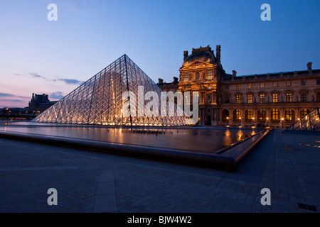 Louvre courtyard and pyramid at dusk Paris, France Stock Photo