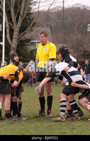 Referee with junior rugby young players in club competition match preparing to scrum scrummage down EDITORIAL USE ONLY Stock Photo