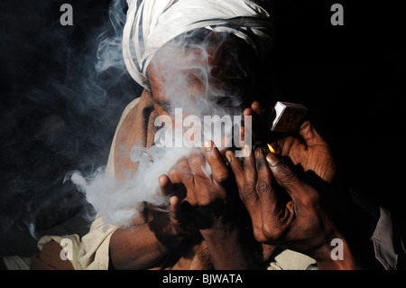 Hindu holy man smoking hashish. Stock Photo