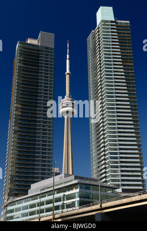 New unfinished downtown high rise Condo towers in Toronto with the CN tower against a blue sky Stock Photo