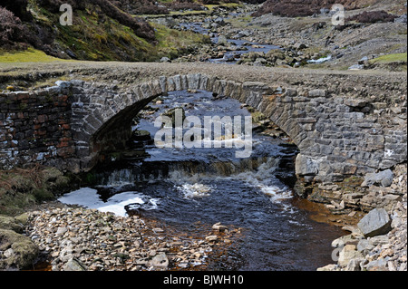 Packhorse bridge over Old Gang Beck Old Gang lead mines, Swaledale, Yorkshire Dales National Park, Yorkshire, England, U.K. Stock Photo