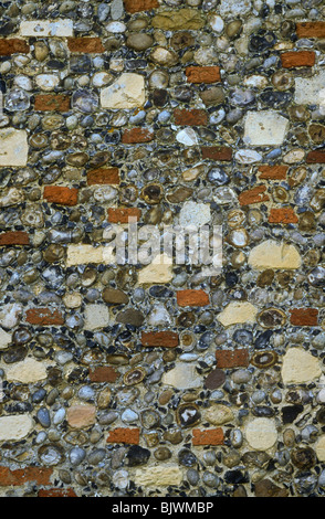 Flint, brick and stone wall, on old church, Suffolk Stock Photo