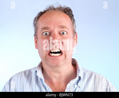 A middle-aged man is enraged about something Stock Photo