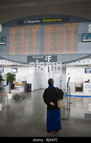 passengers looking at departure announcement board, Terminal 2, Charles de Gaulle airport Roissy, France Stock Photo