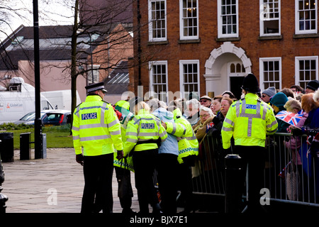 Police help an elderly lady from behind the crowd barrier in Derby at the Maundy Thursday celebrations and take her to sit down. Stock Photo