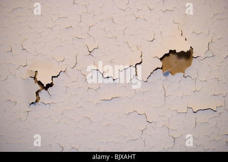 Paint cracking on an interior wall of a house. Stock Photo